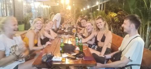a group of young people sitting at a table at Central Backpackers Hostel - Phong Nha in Phong Nha