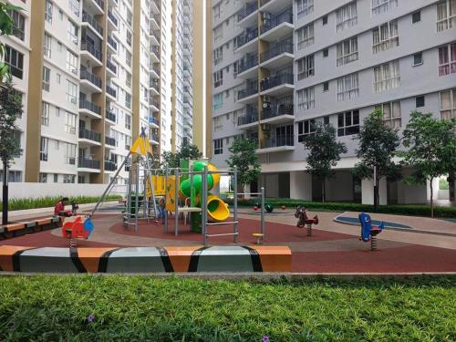 a playground in a park in a city with buildings at Condo with pool-Muslim friendly in Kuala Lumpur