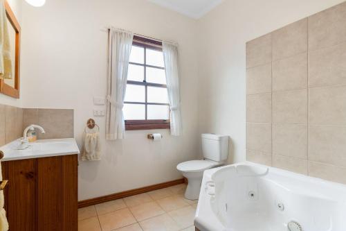 a bathroom with a tub and a toilet and a sink at Northway Downs Estate Vineyard in Balnarring