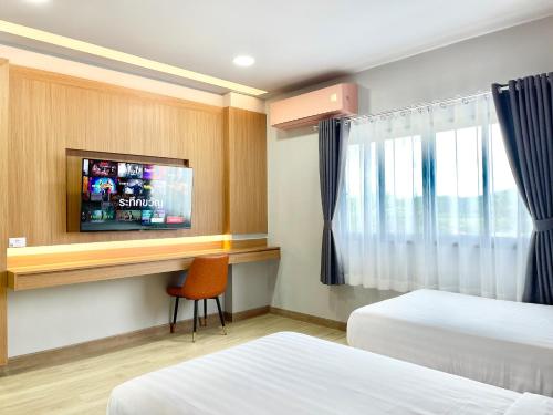 a hotel room with two beds and a flat screen tv at Air Diamond Hotel in Ban Nong Khong