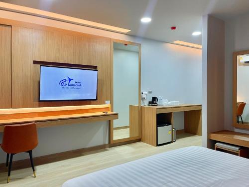 a hotel room with a tv on a wall at Air Diamond Hotel in Ban Nong Khong