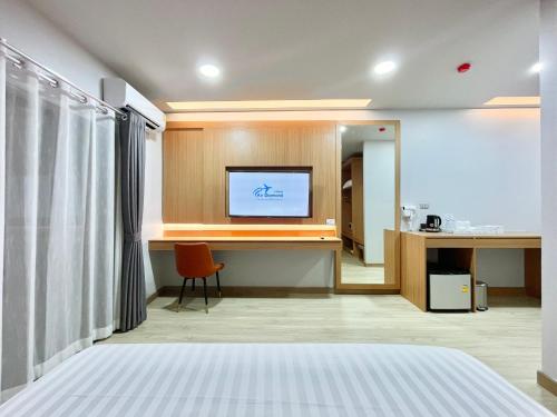 a hotel room with a bed and a flat screen tv at Air Diamond Hotel in Ban Nong Khong