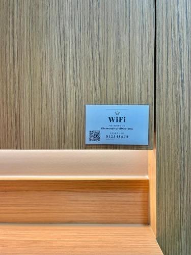 a sign sitting on top of a wooden wall at Air Diamond Hotel in Ban Nong Khong