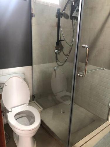 a bathroom with a toilet and a shower at Wooden house in the centre of Chiangmai self-checkin in Chiang Mai
