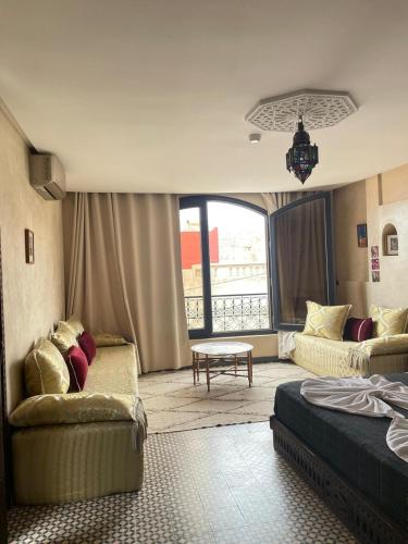a living room with two couches and a table at Auberge RIAD DLIM Tamraght in Tamraght Ouzdar