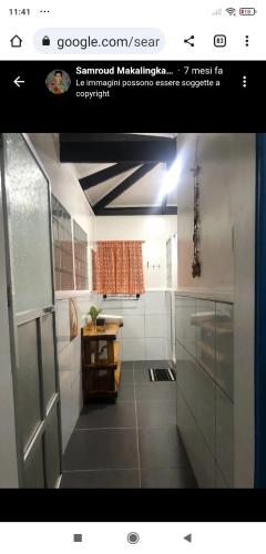 a screenshot of a kitchen with a picture of a bathroom at Sun House Rental in Mambajao