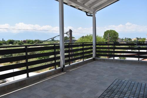 a view from the balcony of a house with a fence at Villa Olympia in Paralia Katerinis