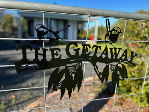 a sign that reads the garden on a fence at The Getaway - Galston in Galston