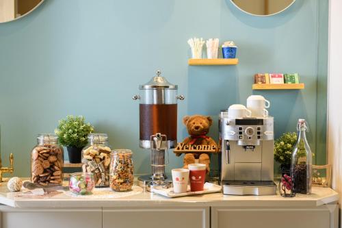 a counter with a coffee maker and food on it at Hotel Sobial Namba Daikokucho in Osaka