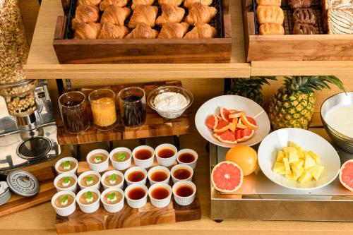 a bunch of food on a shelf in a kitchen at Hotel Sobial Namba Daikokucho in Osaka