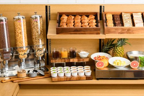 a kitchen with a buffet of food on shelves at Hotel Sobial Namba Daikokucho in Osaka