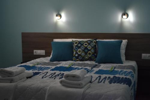 a bedroom with a bed with towels on it at Villa Olympia in Paralia Katerinis