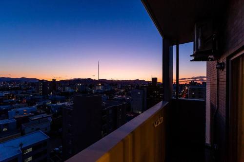 a view of a city skyline at sunset from a building at GRAVITY in Sapporo