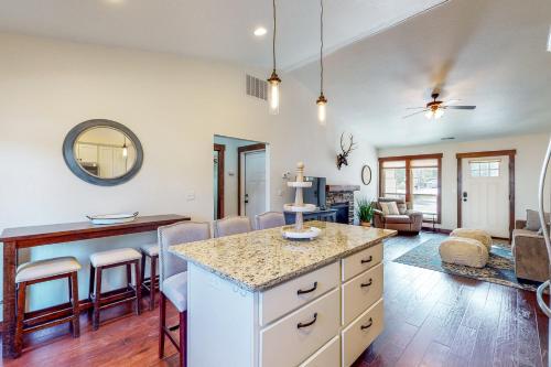 a kitchen and living room with a table and chairs at Craftsman Comforts in Sandpoint