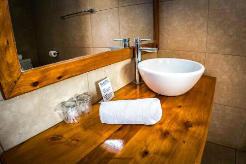 a bathroom with a sink and a mirror at Taha Tai in Hanga Roa