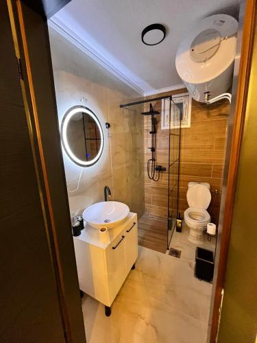 a bathroom with a sink and a shower and a toilet at Apartman Lile Raca in Ohrid