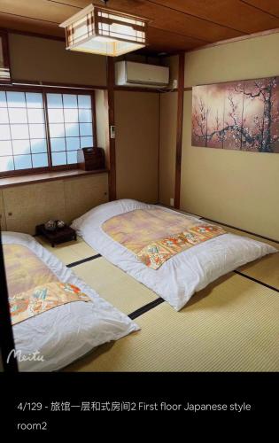two beds in the corner of a room at 京町屋 京都*缘屋kyoto*Enishiya 开业特价&免费早餐供应 NewOpen in Kyoto