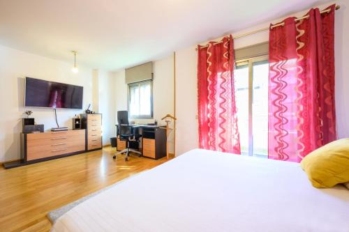 a bedroom with a white bed and red curtains at Apartamento Litoral Blue in Málaga