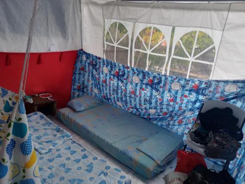 a room with a couch in a tent at VOLUNTARY & Camping in Cozumel