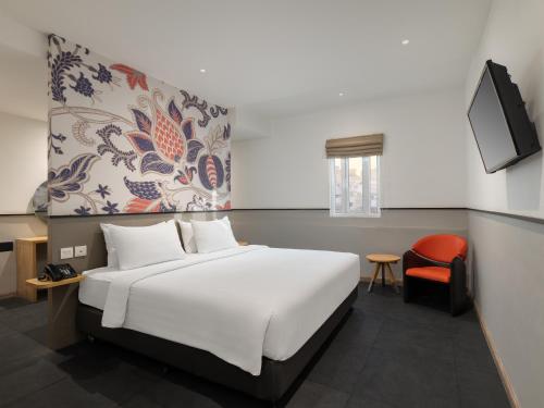 Un pat sau paturi într-o cameră la Swiss-Belinn Medan