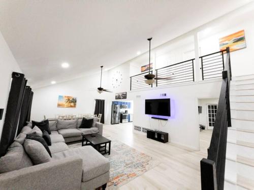 a living room with a couch and a tv at Roomy Home 5 mins from attractions in Galveston