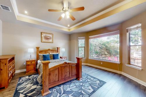 a bedroom with a bed and a ceiling fan at Captivating Cottage in New Braunfels