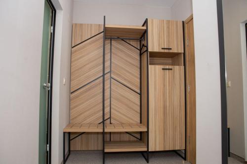 a closet in a room with wooden doors at Hotel Forum City in Pazardzhik