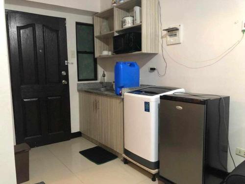 a small kitchen with a sink and a refrigerator at L & R Staycation in Imus