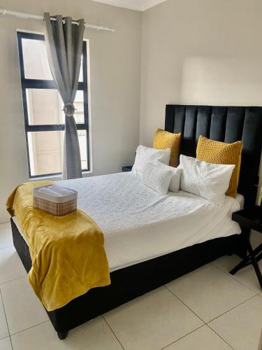 a large bed in a room with a window at Ladybug unit 3 (2) in Midrand