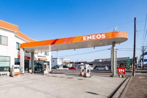 a gas station with an emissions sign at a gas station at The Landscape in Kami-furano