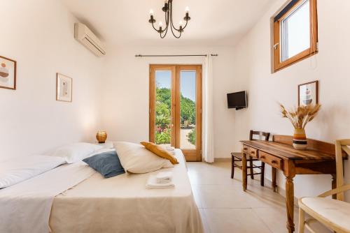 a bedroom with a bed and a table and a desk at Villa Mazzella in Procida