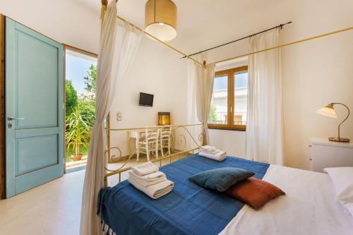 a bedroom with a canopy bed with towels on it at Villa Mazzella in Procida