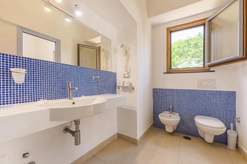 a bathroom with a sink and a toilet at Villa Mazzella in Procida