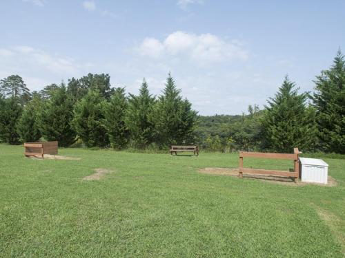 two benches in a field with trees in the background at MVC - Unit 2602 - Sweet Serenity in Pigeon Forge