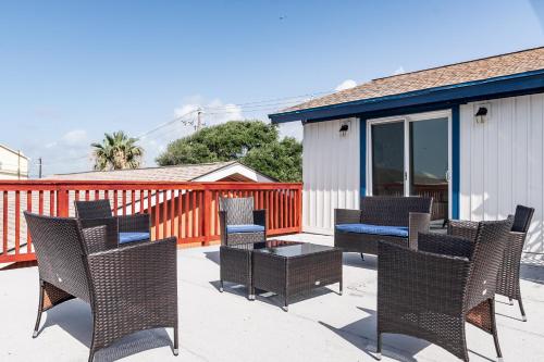 a group of chairs and tables on a patio at Roomy Home 5 mins from attractions in Galveston