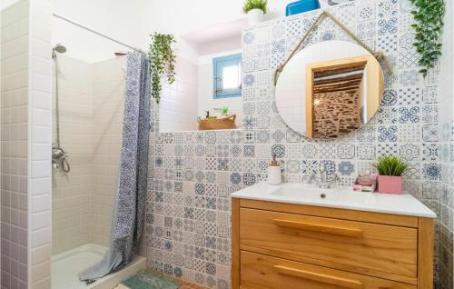 a bathroom with a sink and a shower and a mirror at Cozy Home In Adra With House A Mountain View in Adra