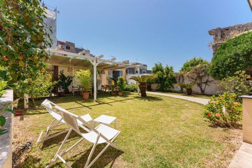 a white chair sitting in the yard of a house at Villa Mazzella in Procida