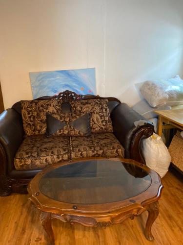 a living room with a couch and a coffee table at House Rooms & RV Rooms Near LAX in Los Angeles
