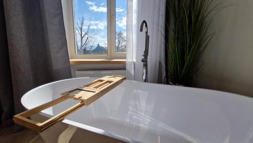a white bath tub with a ladder on top of it at ATF Apartments in Riga