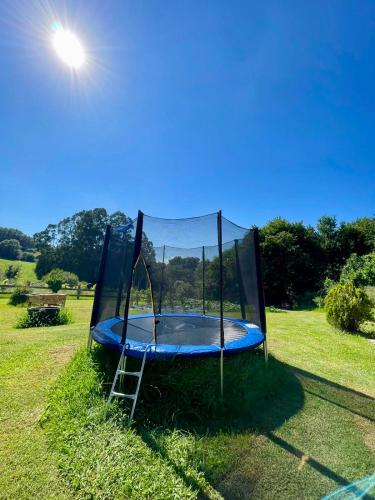 a trampoline in a field with the sun behind it at Caserio Kamirune in Laukiz