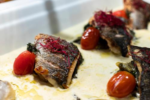 a plate of food with meat and tomatoes on it at Apollon Hotel in Kos Town