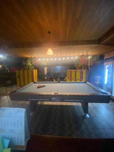 a large white pool table in a room at DownTown Backpackers Hostel in Luang Prabang