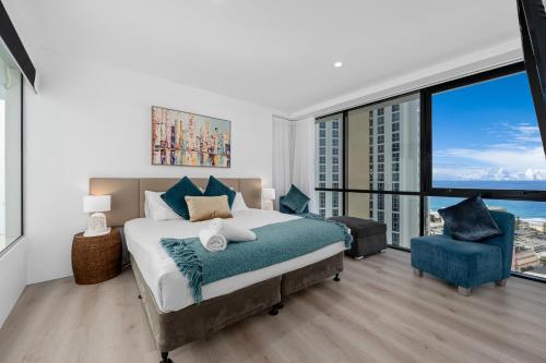 a bedroom with a bed and a large window at Circle on Cavill Contemporary Luxury and Spacious Three Bedroom Apartment in Gold Coast