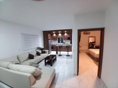 ein Wohnzimmer mit einem Sofa und einem Tisch in der Unterkunft apartamento a 15 mins del centro in Tepic