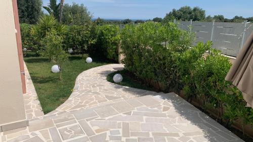 a garden with white balls on the grass at Tenuta Verdolivo in Ostuni