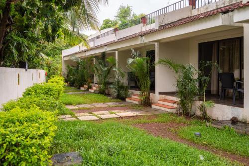 a house with a garden in front of it at The Banyan Soul in Anjuna