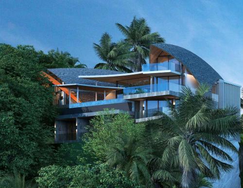 a building with a curved roof and palm trees at 苏梅岛观景台海景別墅Golden Coconut Villa 5 超级海景 私密泳池 接送服务 in Koh Samui 
