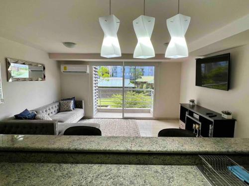 a living room with a couch and a tv at Modern Condo in Ecovivienda in Tegucigalpa