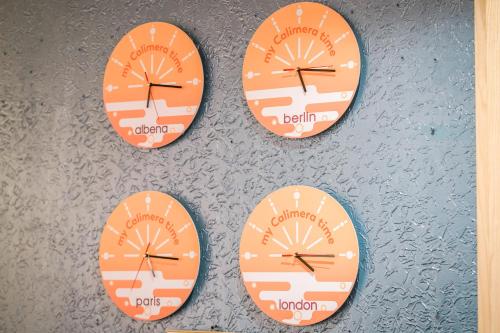 three clocks on a wall with a clock on it at Calimera Ralitsa Superior Hotel - Ultra All Inclusive plus Aquapark in Albena
