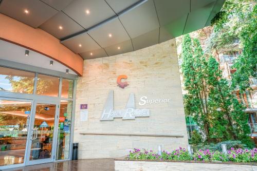 a store with a sign on the side of a building at Calimera Ralitsa Superior Hotel - Ultra All Inclusive plus Aquapark in Albena